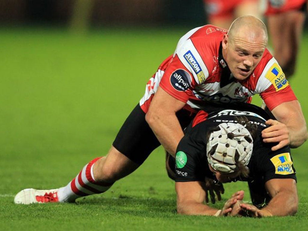 Mike Tindall of Gloucester brings Schalk Burger to his knees on Saturday