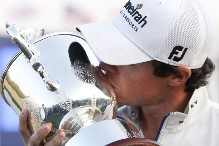 Rory McIlroy kisses his trophy after winning the Shanghai Masters