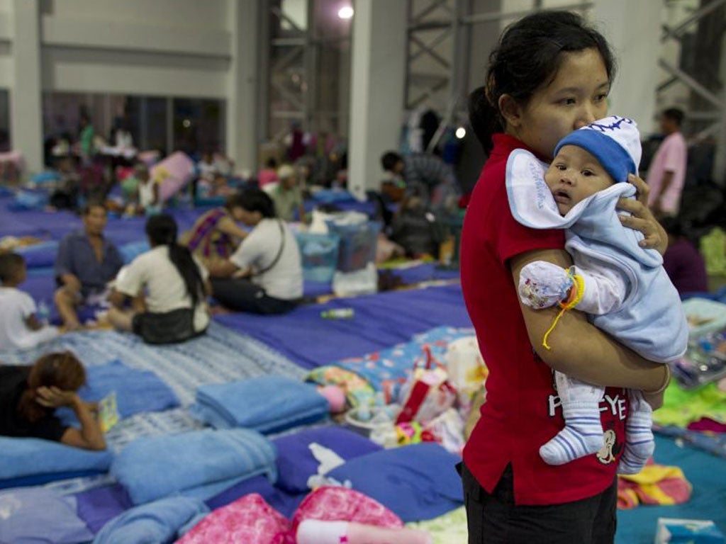 A mother and baby at an evacuation centre in Bangkok yesterday