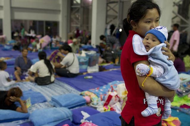 A mother and baby at an evacuation centre in Bangkok yesterday 