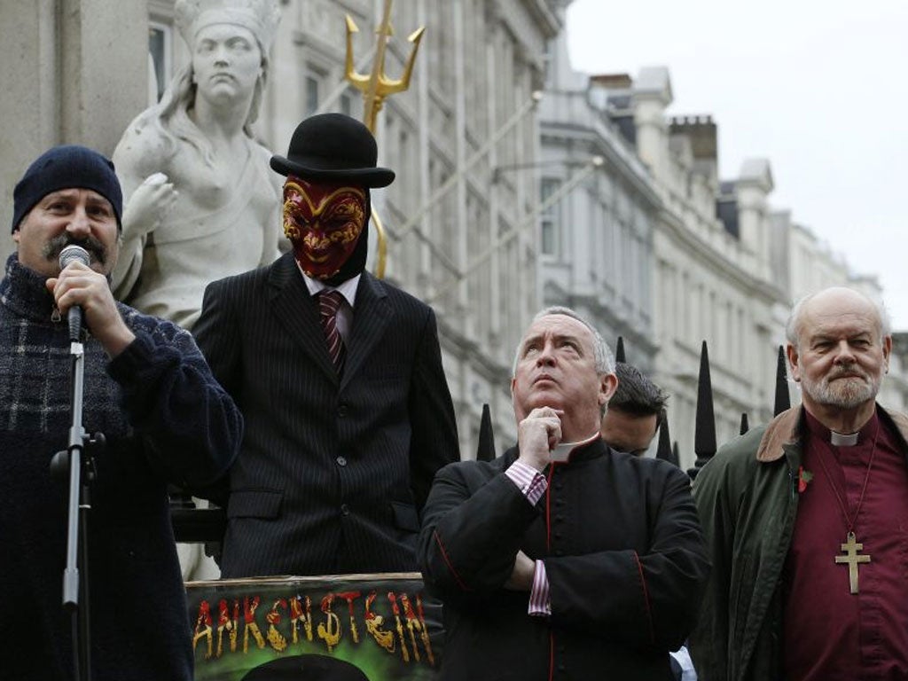 The Dean of St Paul's, Graeme Knowles, second right, and  the Bishop of London, Richard Chartres, right, are questioned yesterday by the protesters they are trying to evict