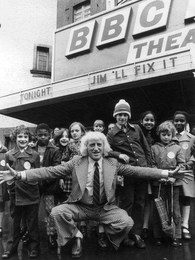 Jimmy Savile in 1974 with children who took part in his series of  'Jim'll Fix It'