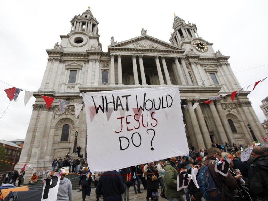 A banner which reads "What would Jesus do?" flies outside St. Paul's Cathedral in London