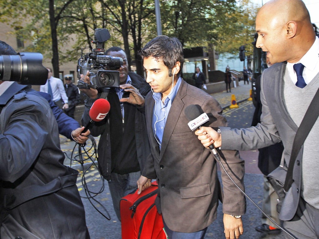 Salman Butt is surrounded by the media as he leaves court yesterday