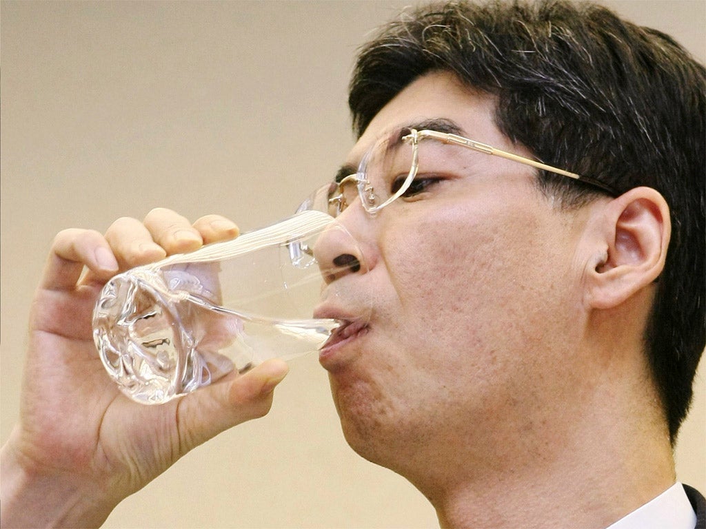 Yasuhiro Sonoda drinks water from inside the reactor