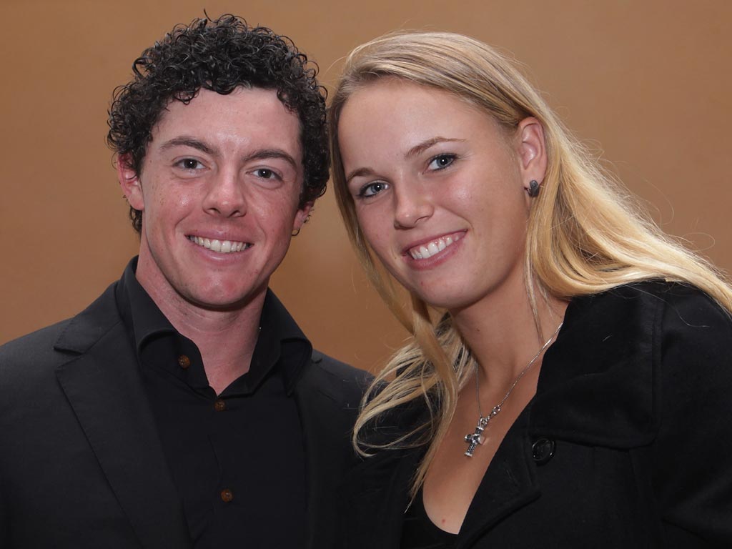 Rory McIlroy of Northern Ireland poses alongside his girlfriend Caroline Wozniacki