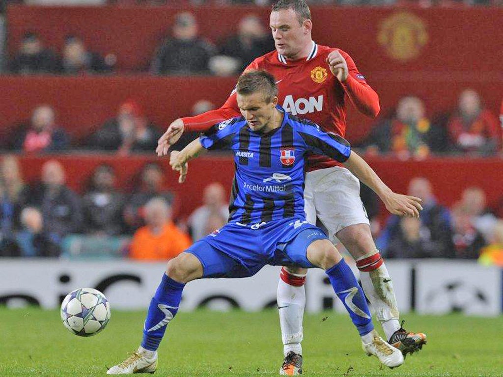Otelul Galati's Ionut Neagu shields the ball from Wayne Rooney
