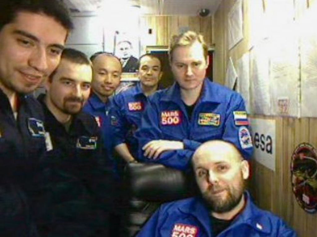 The crew of volunteers during their mission. Blue lights were set up to help them prepare their eyes for daylight after their mocked-up voyage
