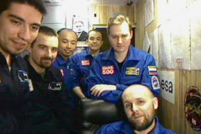 The crew of volunteers during their mission. Blue lights were set up to help them prepare their eyes for daylight after their mocked-up voyage