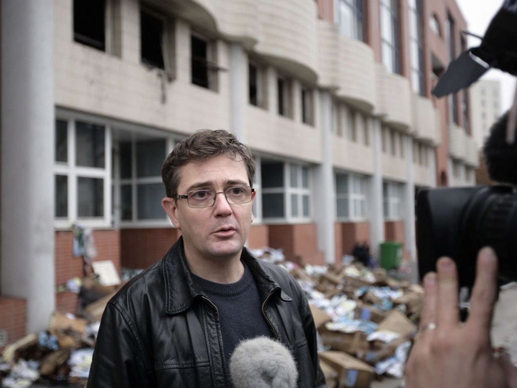 Stéphane Charbonnier, editor of Charlie Hebdo, outside its burnt-out offices yesterday