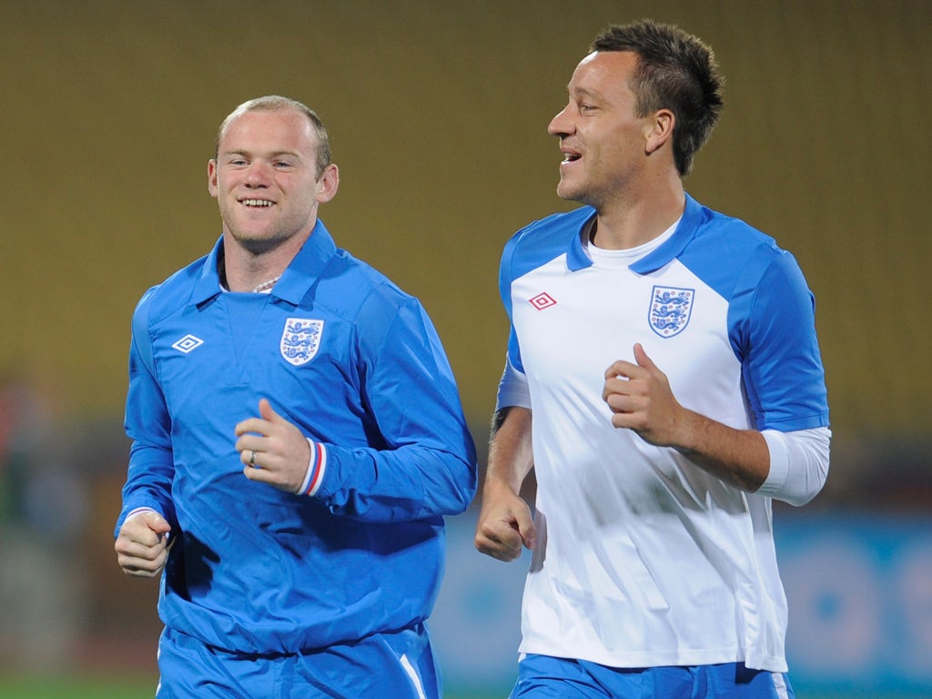 Wayne Rooney and John Terry share a joke during an England
training session