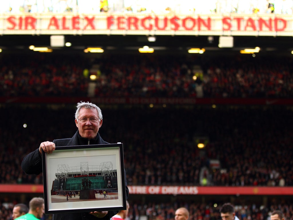 Sir Alex Ferguson is presented with a photo to commemerate his 25th year as manager, as the North Stand is renamed the 'Sir Alex Ferguson Stand'