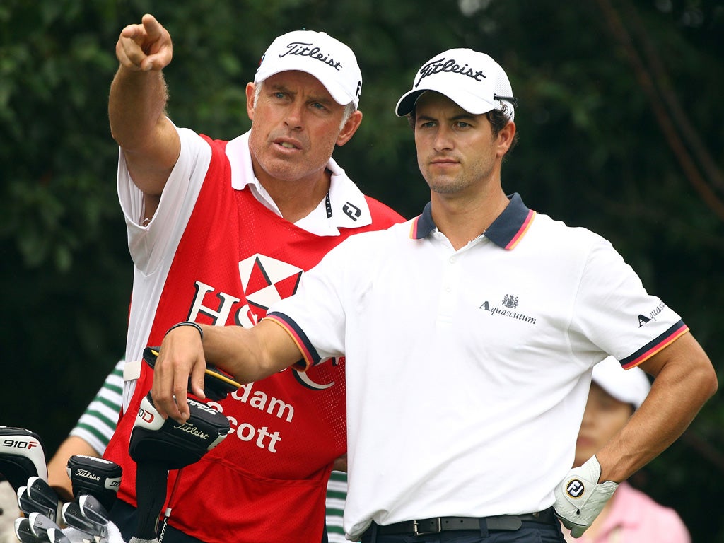 Staying strong: Steve Williams (left) advises Adam Scott, who fired 69 yesterday to be three shots off the lead in Shanghai