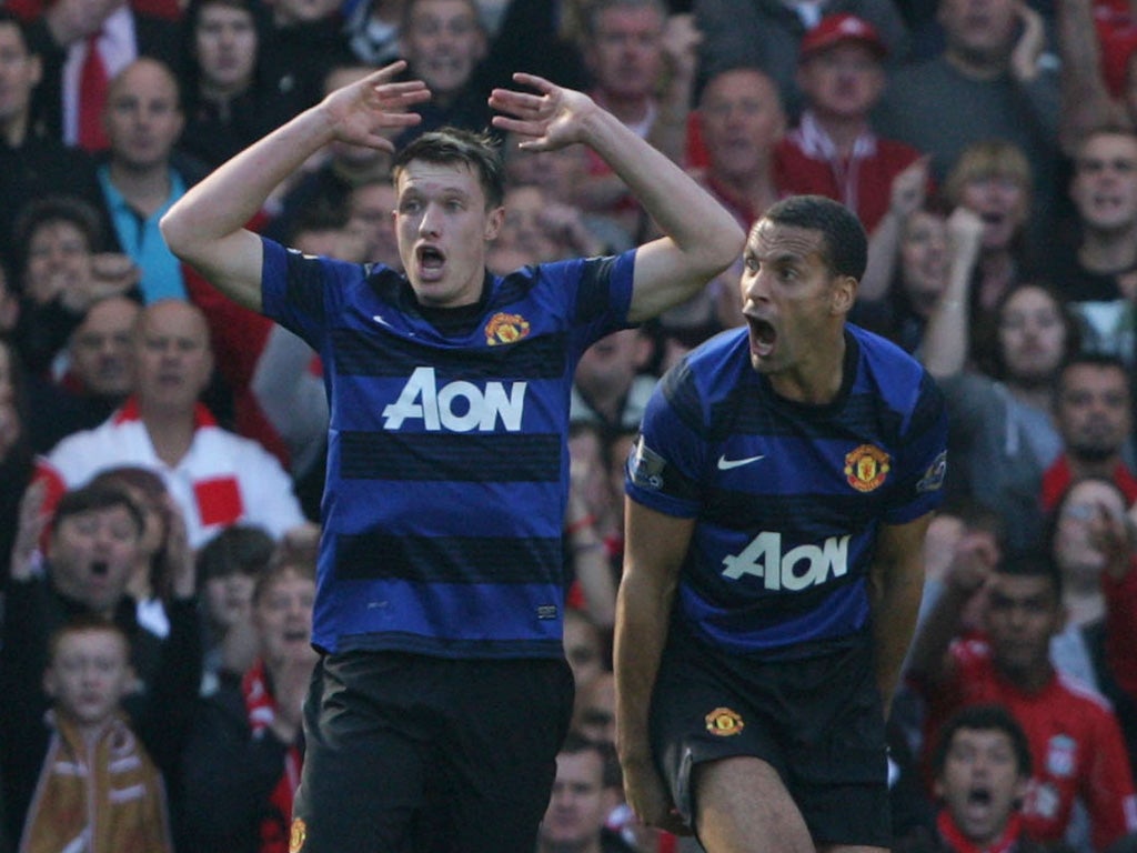 In with a shout: Phil Jones (left) may play in midfield but Rio Ferdinand is out