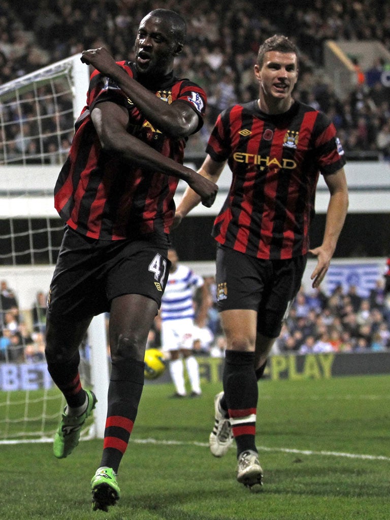 Yaya Touré (left) celebrates scoring the winner with Edin Dzeko