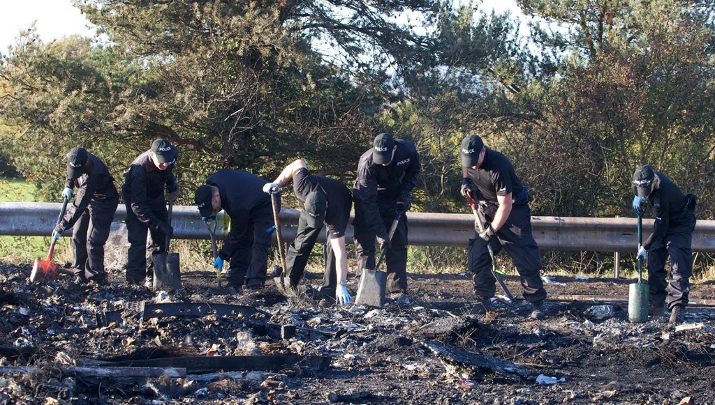 Police search through the debris on the M5