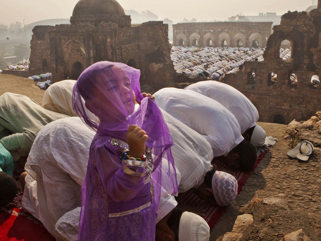 Young girl between thousands prayers as Eid al-Adha, (the festival of sacrifice), gets underway