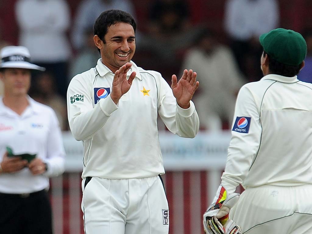 Pakistan's cricketer Saeed Ajmal celebrates with his teammate Adnan Akmal (right) after he dismissed Sri Lanka's Kosala Kulasekara