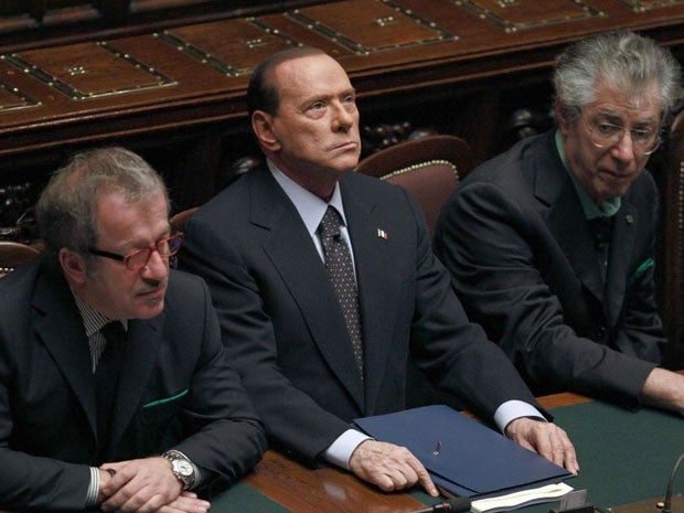 Silvio Berlusconi (centre) sits next to Justice Minister Roberto Maroni (right) and League North Party leader Umberto Bossi during the finance vote