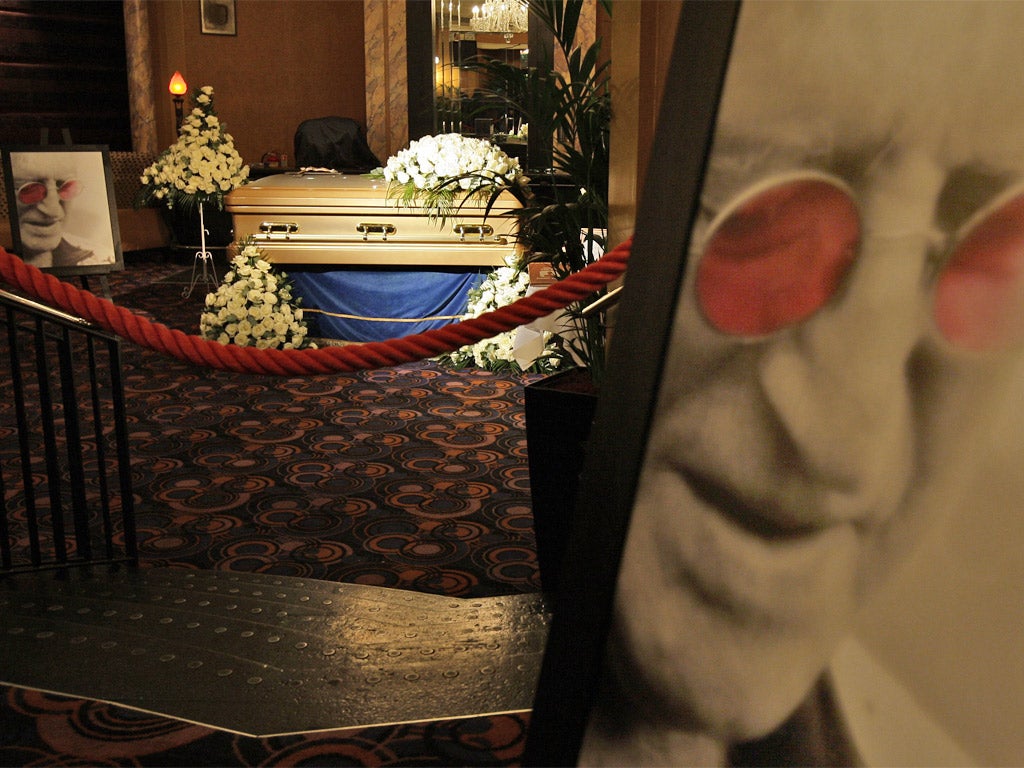 A gold-coloured coffin bearing Sir Jimmy Savile's body on public display at the Queen's Hotel, Leeds