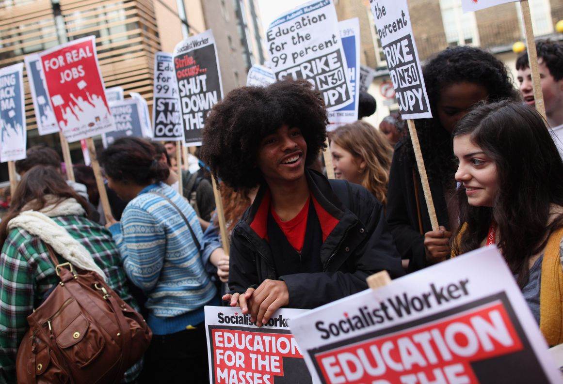 Students gather outside the University of London Union building ahead of the fees protest march