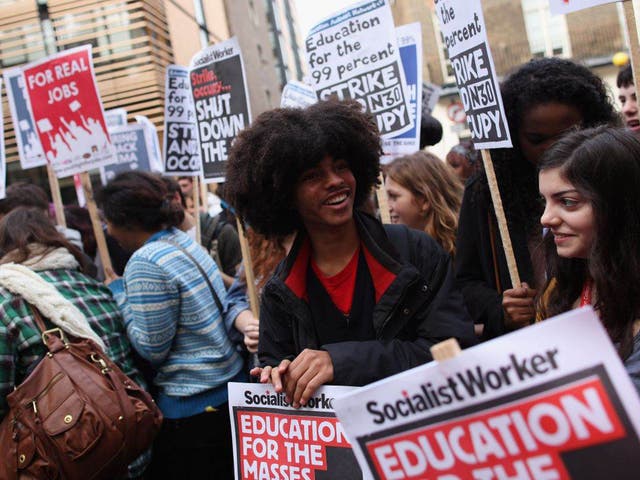 Students gather outside the University of London Union building ahead of the fees protest march