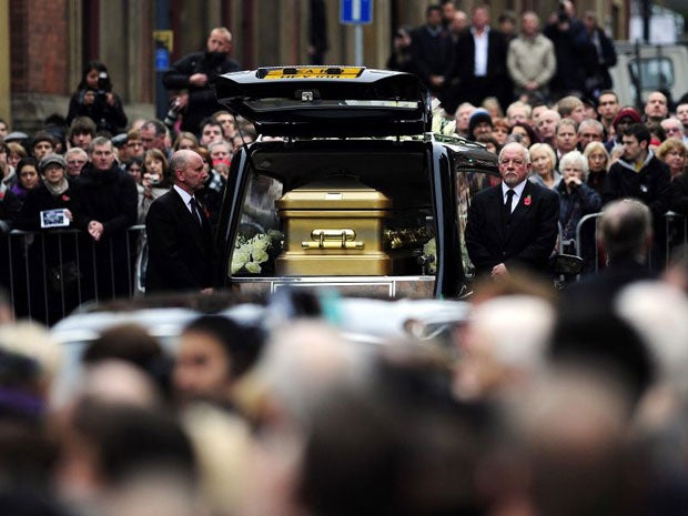 The coffin of Sir Jimmy Savile arrives outside St Anne's Cathedral in Leeds, where his funeral took place