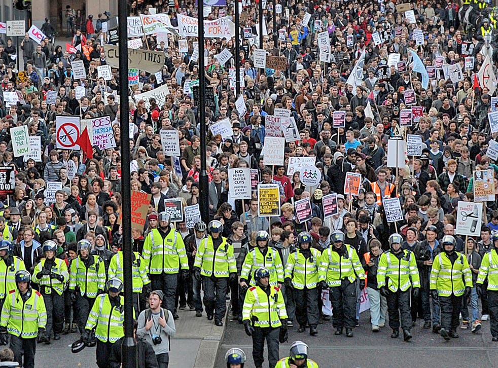 Police lead students through central London yesterday