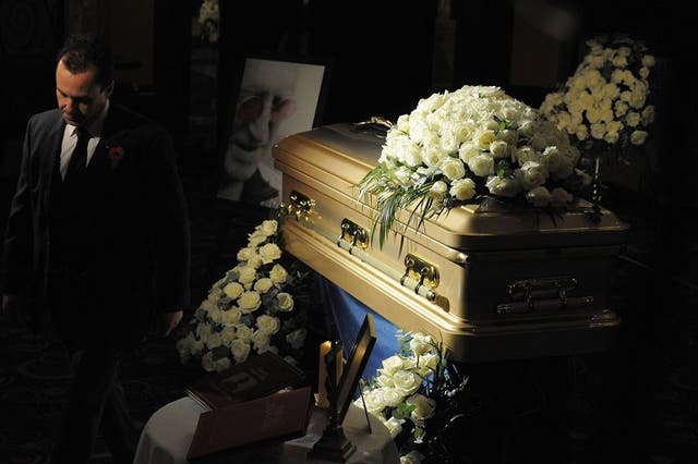Tracksuited and booted: Jimmy Savile's coffin at the Queens Hotel in Leeds on Tuesday