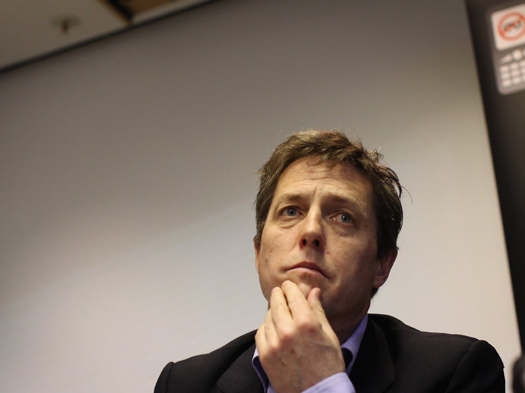 Hugh Grant (pictured) has employed guards to protect Tinglan Hong and their baby