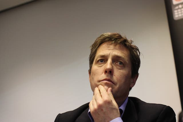 Hugh Grant (pictured) has employed guards to protect Tinglan Hong and their baby