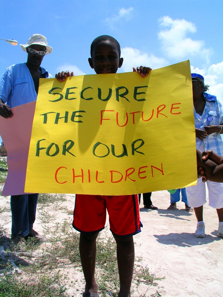 Get the message: A young resident of North Bimini in the Bahamas protests against the construction of a mega-resort