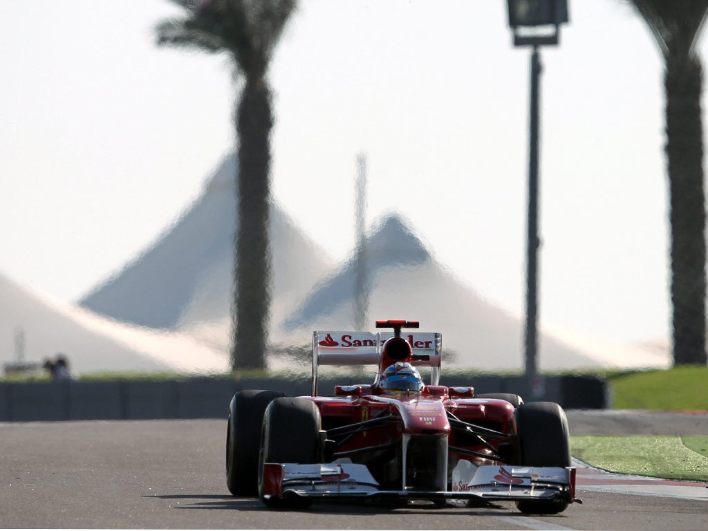 Fernando Alonso races round the Yas Marina circuit but only starts fifth in his Ferrari