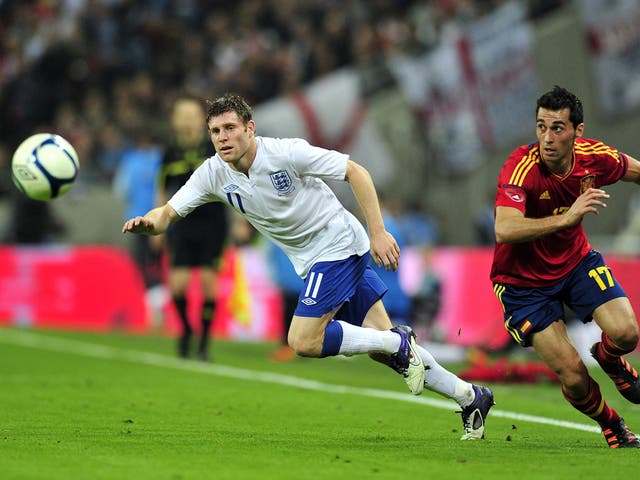 James Milner fends off Spain's Alvaro Arbeloa