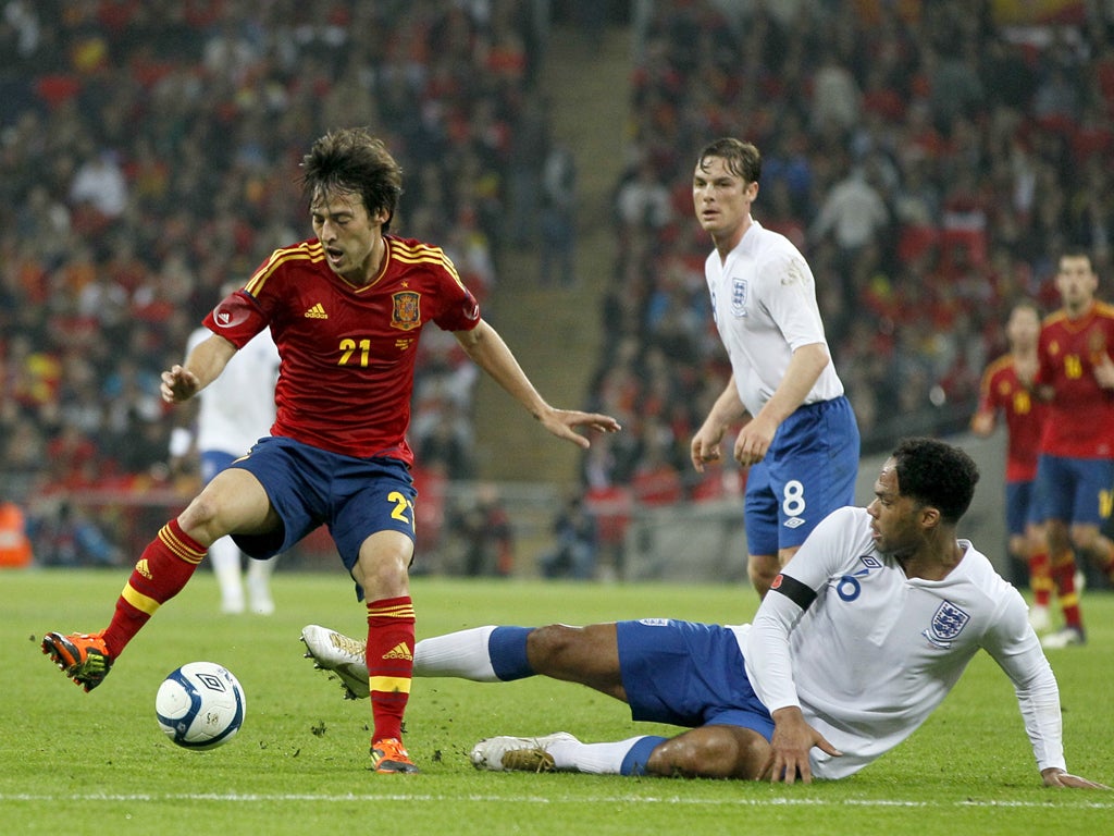 Joleon Lescott tackles David Silva as part of Fabio Capello's defensive set-up which frustrated the attack-minded world champions