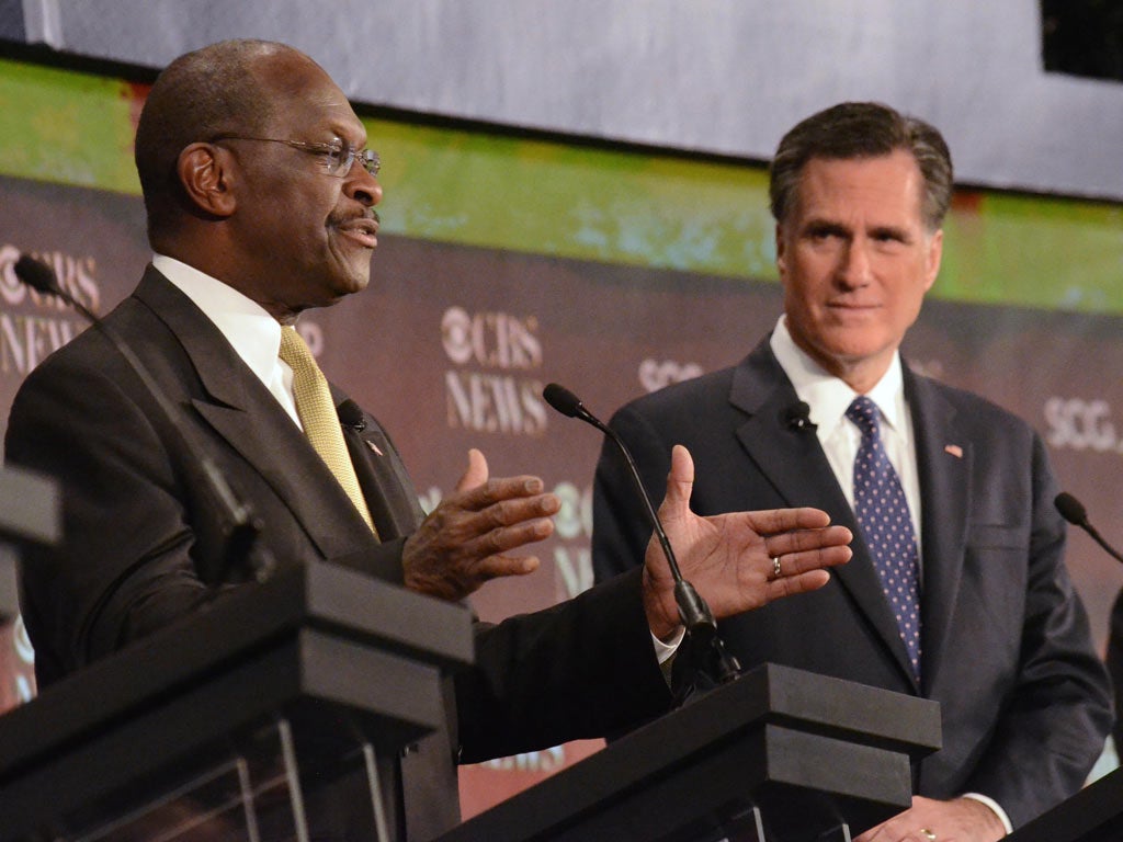 Herman Cain speaks as Mitt Romney, right, looks on during
the foreign policy debate in South Carolina