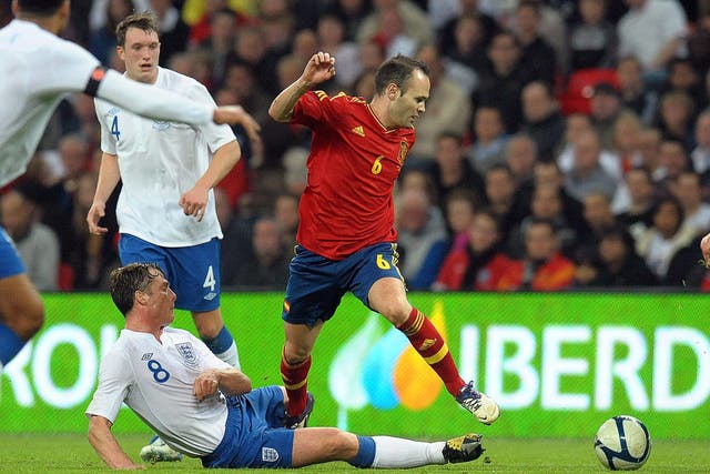 England's man of the match, Scott Parker, slides in to tackle Andres Iniesta