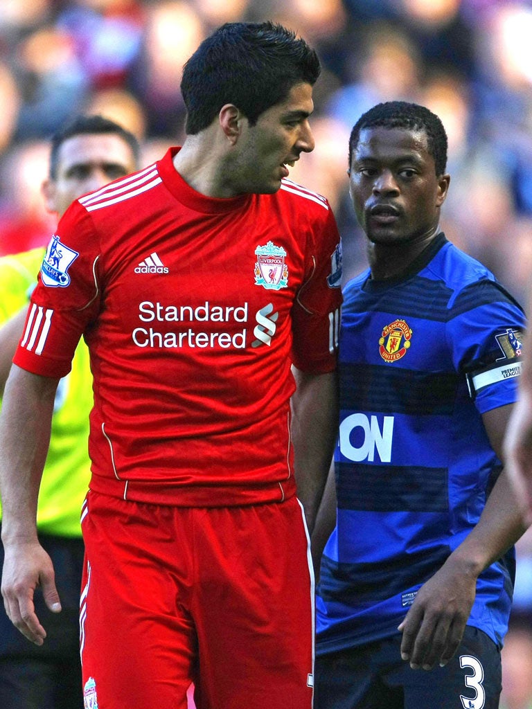 Patrice Evra and Luis Suarez exchange words during the draw at Anfield