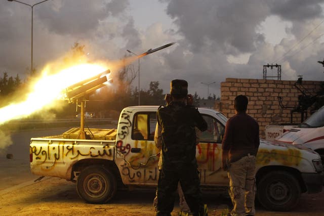 Fighters from Zawiya city fire a rocket towards the Warcfana tribe about 40km outside Tripoli