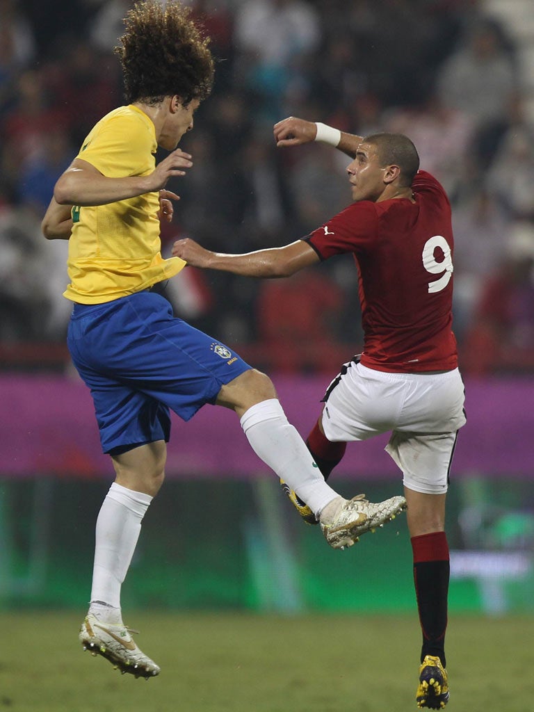 Chelsea’s David Luiz (left) featured for Brazil in a friendly against Egypt in the early winter air in Doha last night. Brazil won 2-0