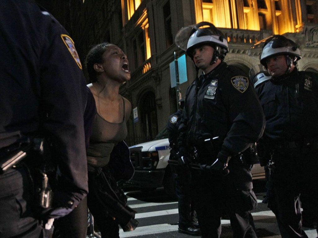 A demonstrator yells at police officers as they order Occupy Wall Street protesters to leave Zuccotti Park