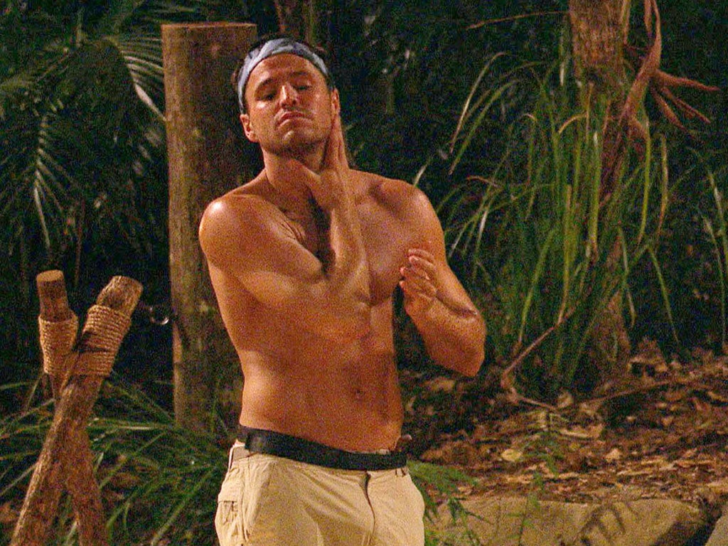 Hunk in trunks: Mark Wright maintains
his skincare regime in the jungle