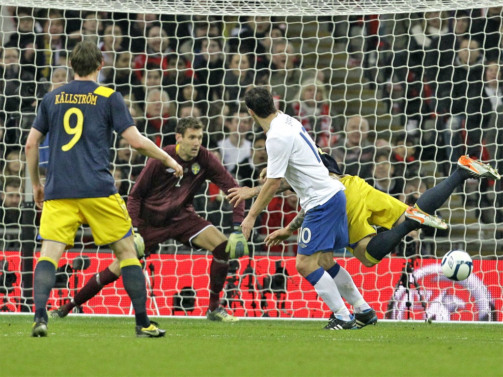 Gareth Barry watches his header beat Andreas Isaksson to give England the lead