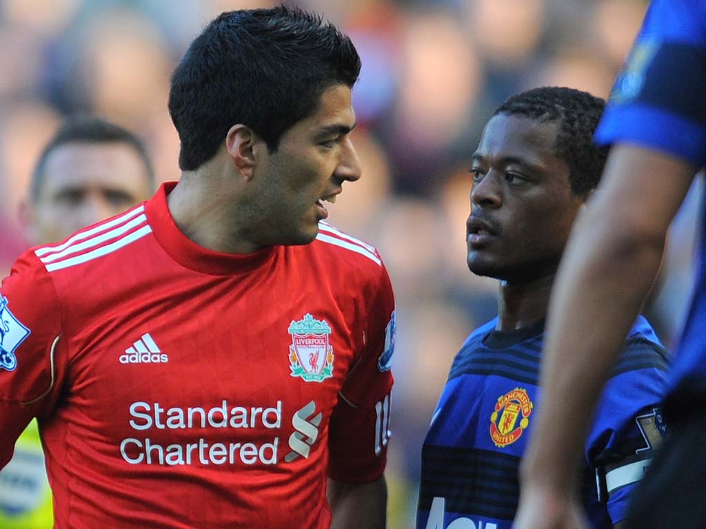 Suarez confronts Evra in the match between Liverpool and Manchester United