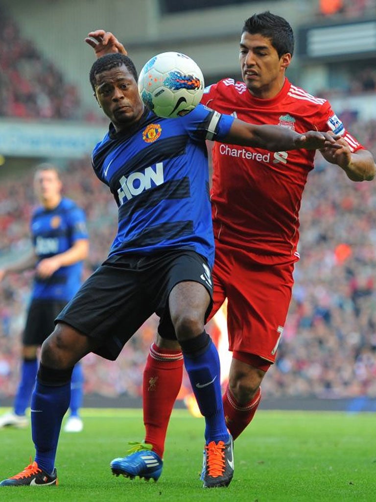 Patrice Evra and Luis Suarez clash during the 1-1 draw at Anfield