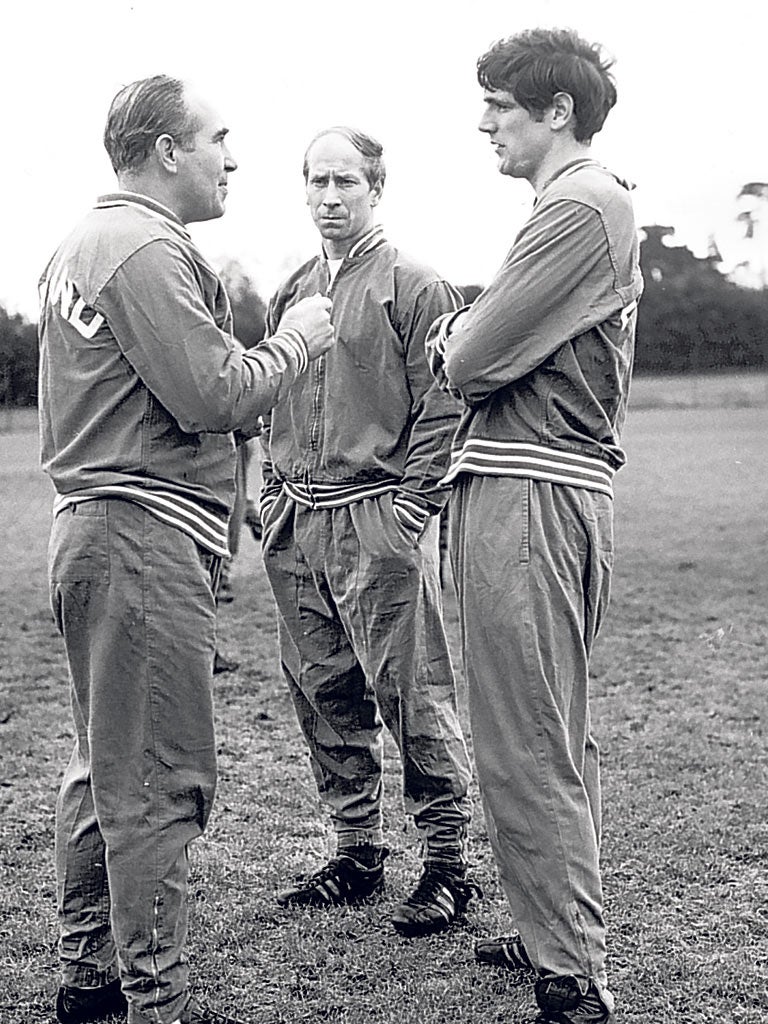 Bobby Charlton (right) listens to the England manager Alf Ramsey