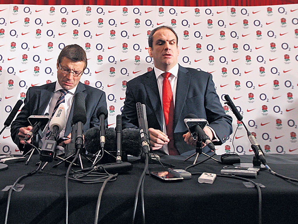 Martin Johnson (right) and Rob Andrew face the cameras as the England manager announces his resignation