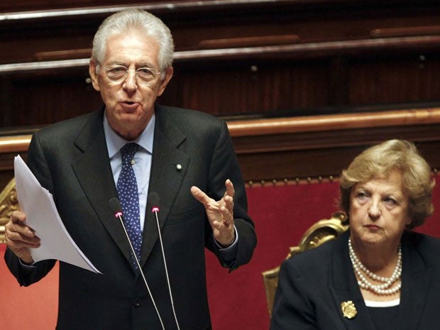 Mario Monti reads his speech next to Interior Minister Anna Maria in the senate today