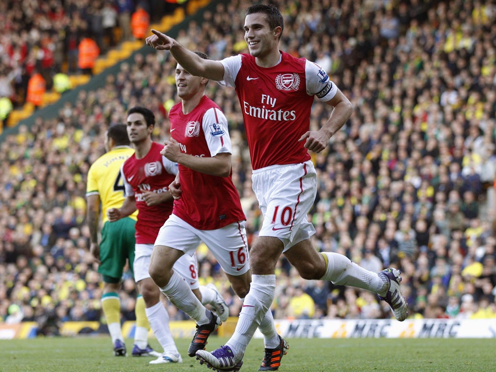 Robin van Persie celebrates one of his two goals in Arsenal's come-from-behind victory at Carrow Road yesterday