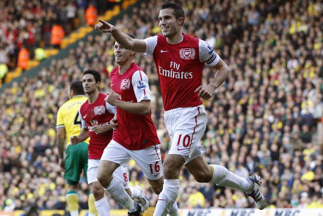 Robin van Persie celebrates one of his two goals in Arsenal's come-from-behind victory at Carrow Road yesterday